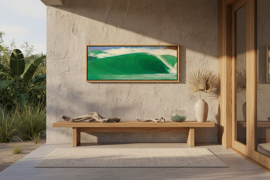 A framed landscape painting of a green ocean wave cresting under a cloudy sky, presented in a light wood frame against a neutral gray background.